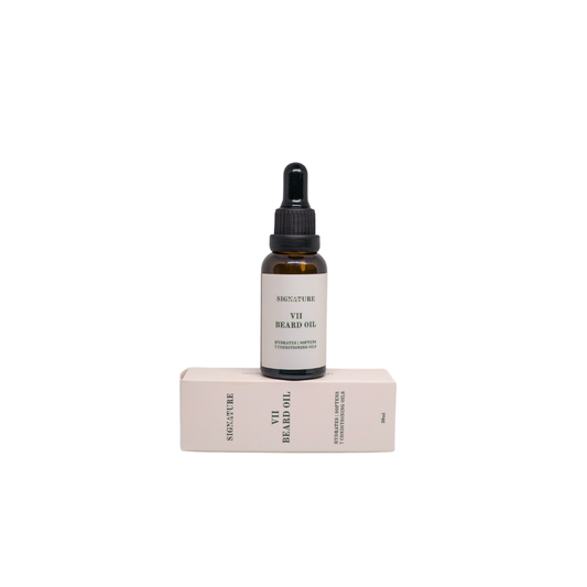 A small amber glass dropper bottle labeled 'VII BEARD OIL' stands upright on top of a pale pink rectangular box against a plain white background.