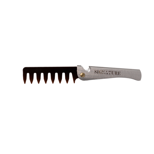 Comb with a metallic handle on a white background