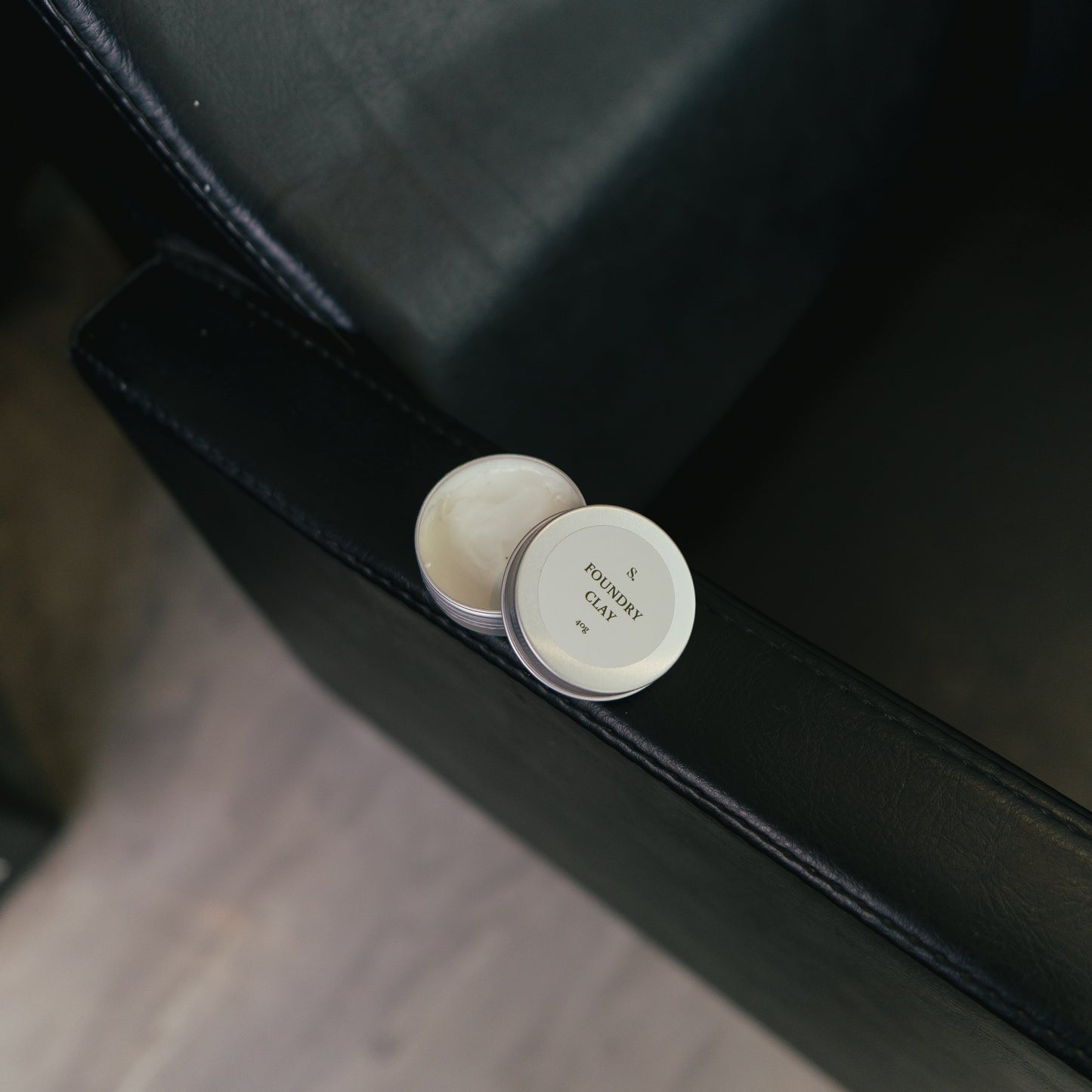 Hair wax for styling on a black surface